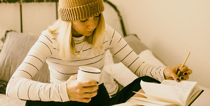 Girl holding notebook looking at notes | Readable, free readability test