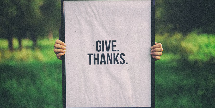 person holding 'give thanks' sign | Readable, free readability test