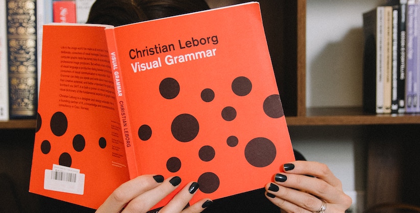 Person reading a visual grammar book